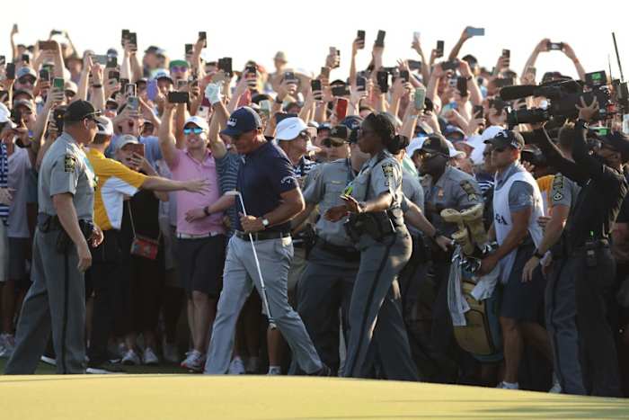Phil Mickelson break through the swarming gallery to approach the 18th hole and victory Sunday in the PGA Championship at Kiawah Island's Ocean Course.